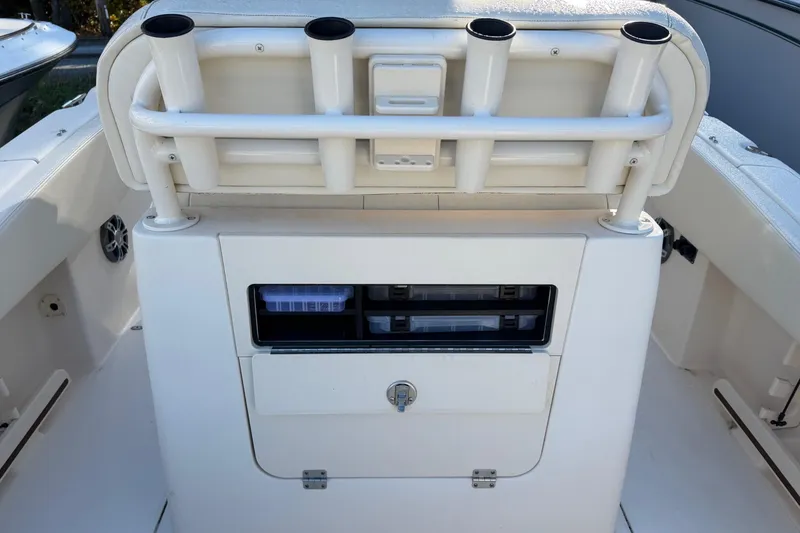 Slide: The Image of 2022 Grady-White Fisherman 257 boat storage compartment with rod holders and tackle boxes. - 11