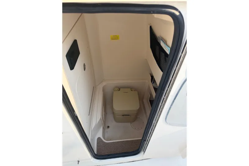 Slide: The Image of 2022 Grady-White Fisherman 257 boat interior with compact marine toilet. - 14