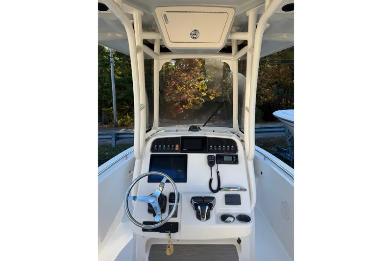 Slide: The Image of 2022 Grady-White Fisherman 257 boat console with steering wheel and controls. - 2