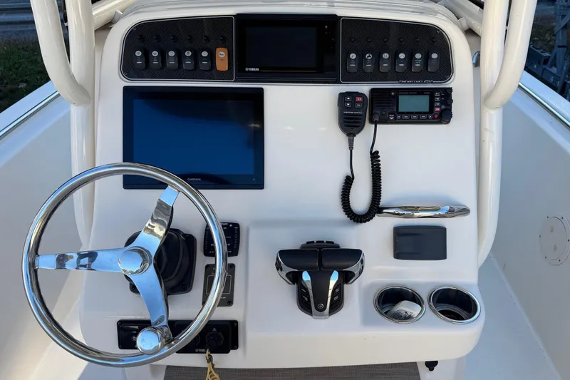 Slide: The Image of 2022 Grady-White Fisherman 257 boat dashboard with steering wheel and electronic controls. - 3