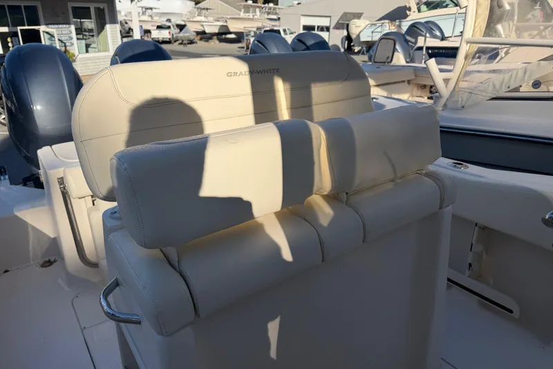 Slide: The Image of 2022 Grady-White Fisherman 257 boat interior with cushioned seating and dual engines. - 8