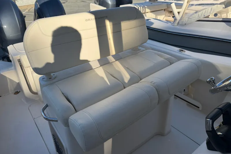 Slide: The Image of 2022 Grady-White Fisherman 257 boat interior with cushioned seating and steering wheel. - 9
