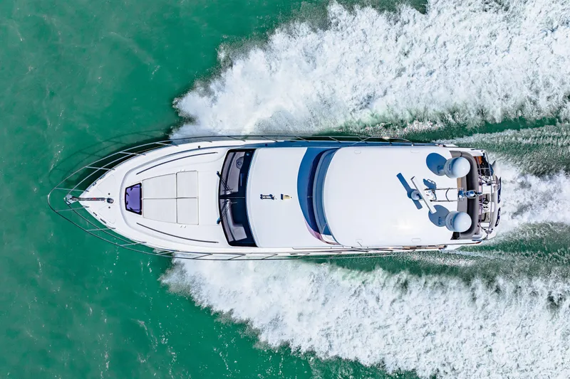 Slide: The Image of Aerial view of 2017 Princess 56 yacht cruising on turquoise water. - 13