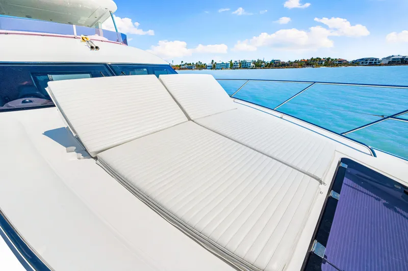 Slide: The Image of Luxury sunbathing deck on 2017 Princess 56 yacht, overlooking serene blue waters. - 45