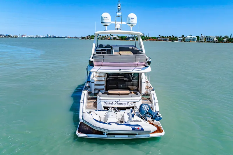 Slide: The Image of Luxury Princess 56 yacht from 2017 on calm waters, featuring a small boat. - 6