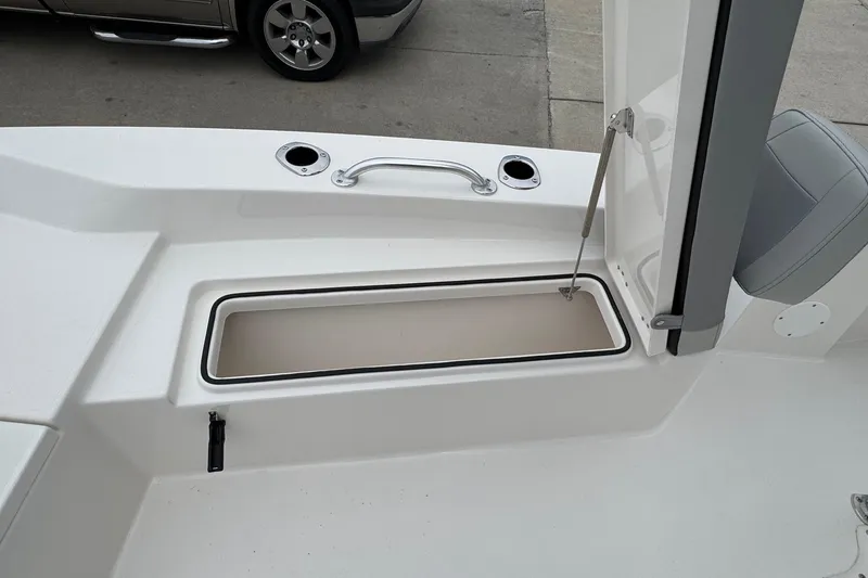 Slide: The Image of 2026 Bay Rider 239 boat interior with open storage compartment and seating. - 10