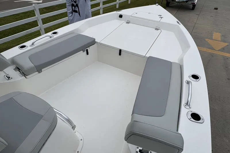 Slide: The Image of 2026 Bay Rider 239 boat interior with gray seating and white deck, showcasing spacious design. - 11