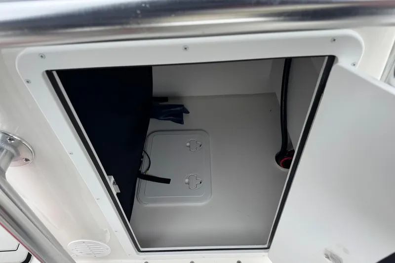 Slide: The Image of Open storage compartment on 2026 Bay Rider 239 boat, featuring interior access and secure latch. - 15