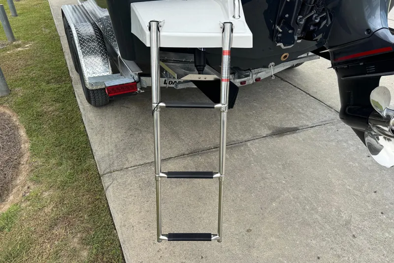 Slide: The Image of Bay Rider 239 boat with ladder and trailer, 2026 model, parked on concrete. - 17