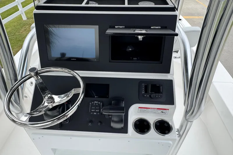 Slide: The Image of 2026 Bay Rider 239 boat console with steering wheel, touchscreen, and controls. - 22