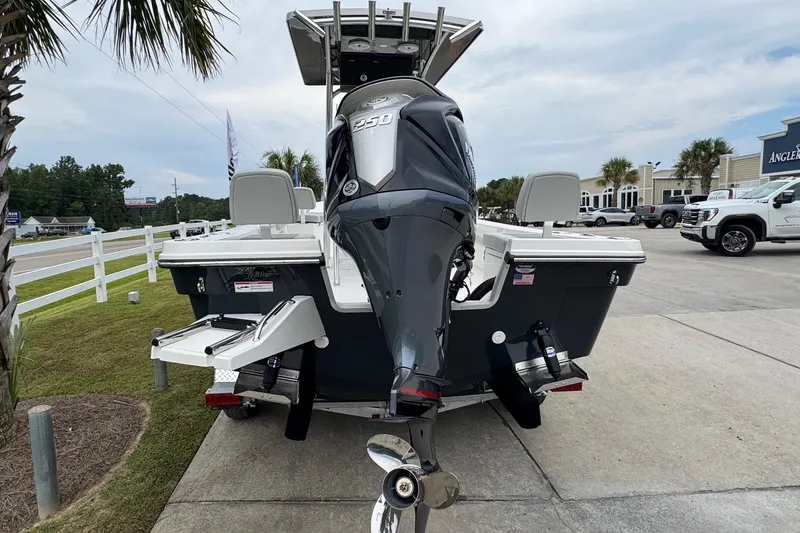Slide: The Image of 2026 Bay Rider 239 boat with powerful outboard motor, parked outdoors. - 4