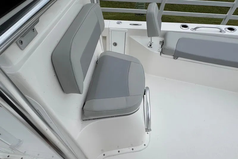 Slide: The Image of 2026 Bay Rider 239 boat interior with gray seating and stainless steel accents. - 8