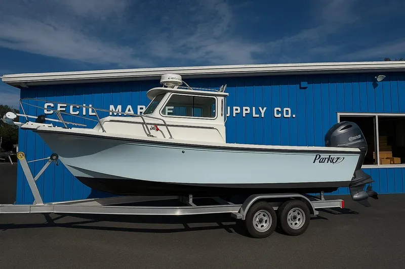 The Image of 2021 Parker 2320 Sport Cabin boat on trailer at marine supply store. - 0