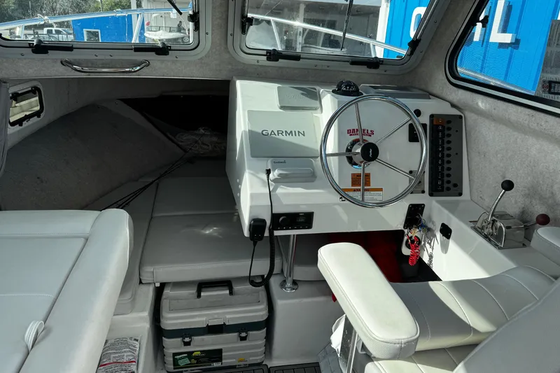 Slide: The Image of Interior of 2021 Parker 2320 Sport Cabin boat with Garmin navigation system and steering wheel. - 12
