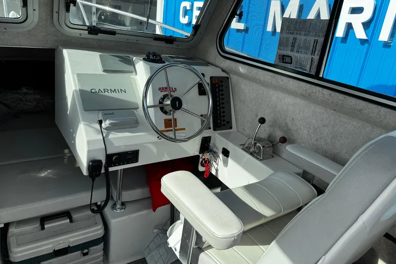 Slide: The Image of Interior of 2021 Parker 2320 Sport Cabin with Garmin navigation system and steering wheel. - 13