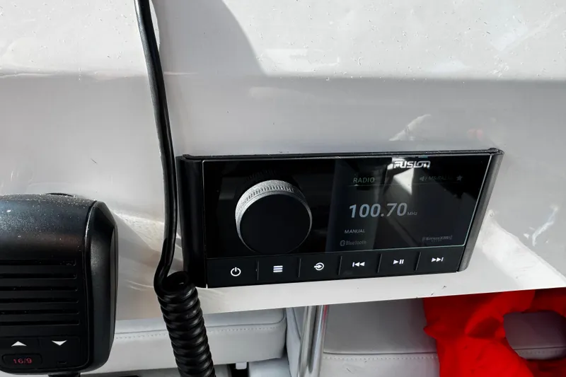 Slide: The Image of Radio system on Parker 2320 Sport Cabin, 2021 model, displaying 100.70 MHz frequency. - 15