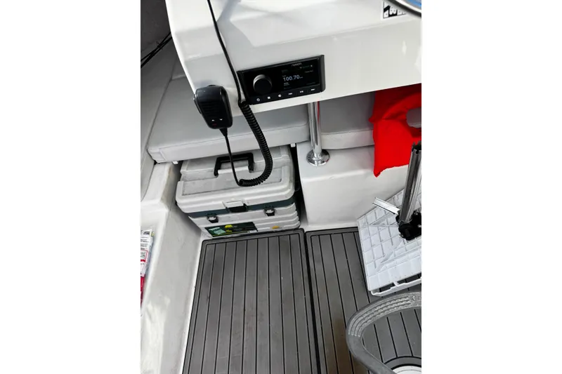 Slide: The Image of 2021 Parker 2320 Sport Cabin interior with radio, storage, and seating. - 20