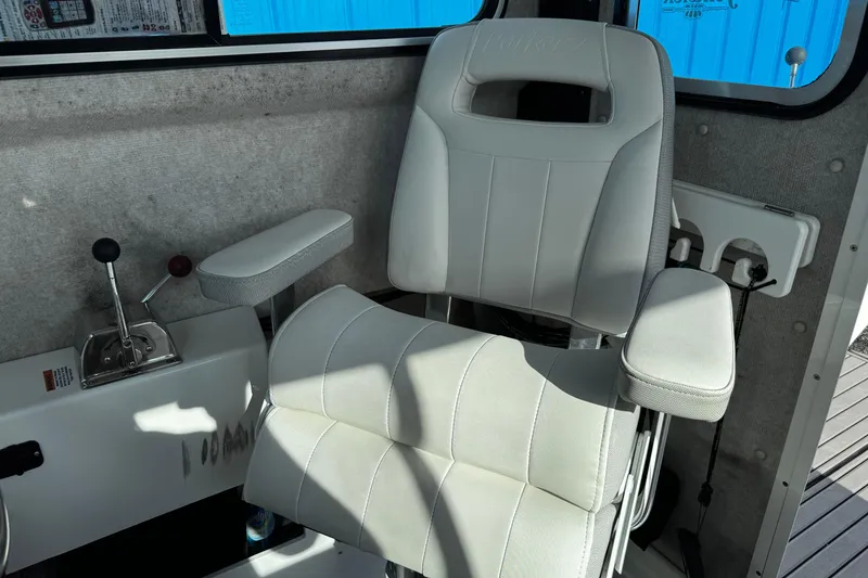 Slide: The Image of Captain's chair in 2021 Parker 2320 Sport Cabin boat interior. - 24