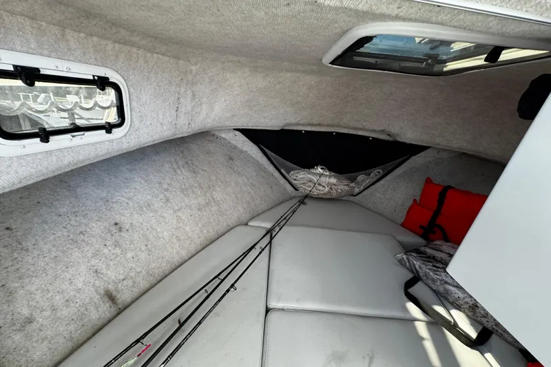 Slide: The Image of Interior cabin of 2021 Parker 2320 Sport Cabin boat with fishing rods and life jackets. - 28