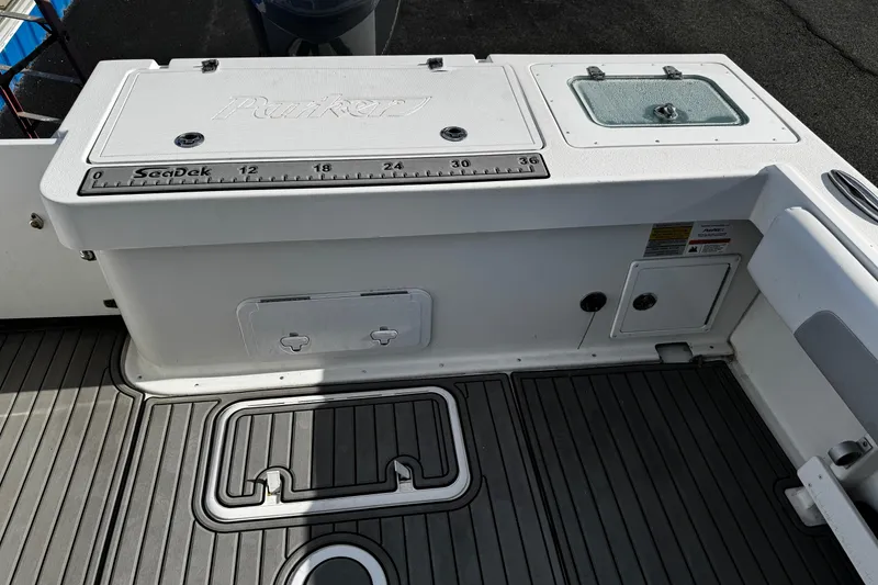 Slide: The Image of Parker 2320 Sport Cabin 2021 boat deck with SeaDek ruler and storage compartments. - 36