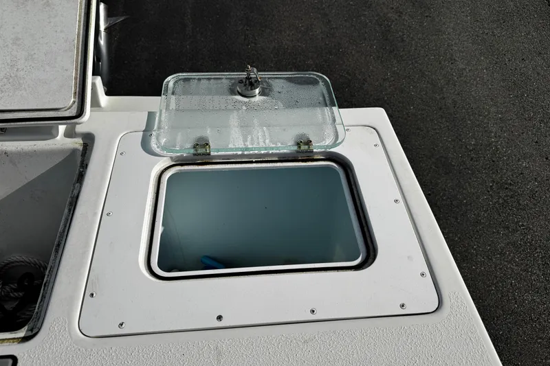 Slide: The Image of Open storage compartment on 2021 Parker 2320 Sport Cabin boat deck. - 38
