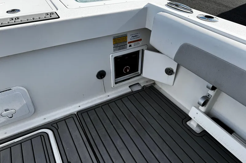 Slide: The Image of 2021 Parker 2320 Sport Cabin interior with storage compartment and non-slip flooring. - 44