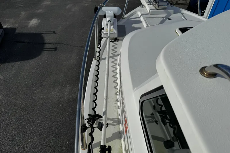 Slide: The Image of 2021 Parker 2320 Sport Cabin boat deck with railing and equipment. - 5