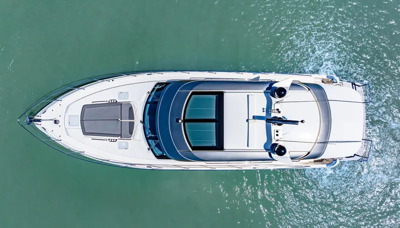 Slide: The Image of Aerial view of 2022 Riviera 5400 Sport Yacht cruising on clear water. - 10