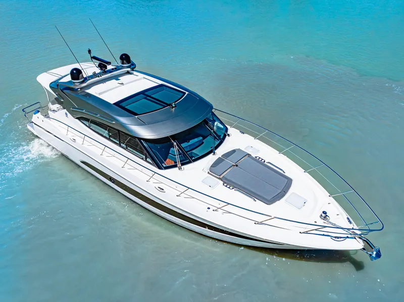Slide: The Image of 2022 Riviera 5400 Sport Yacht cruising in clear blue waters. - 2