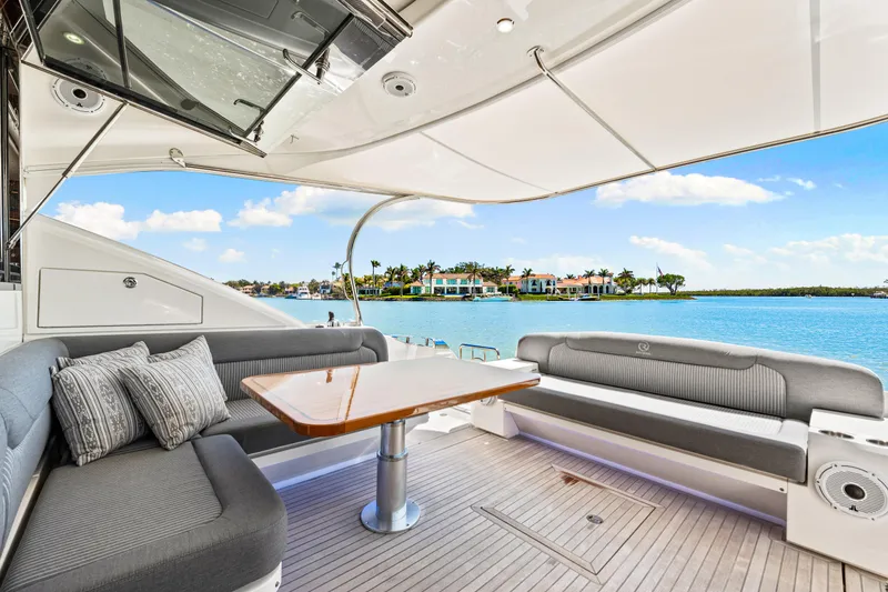 Slide: The Image of 2022 Riviera 5400 Sport Yacht interior with elegant seating and scenic waterfront view. - 42