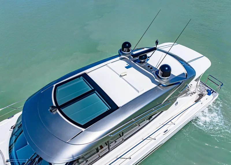 Slide: The Image of 2022 Riviera 5400 Sport Yacht cruising on clear blue water, aerial view. - 9