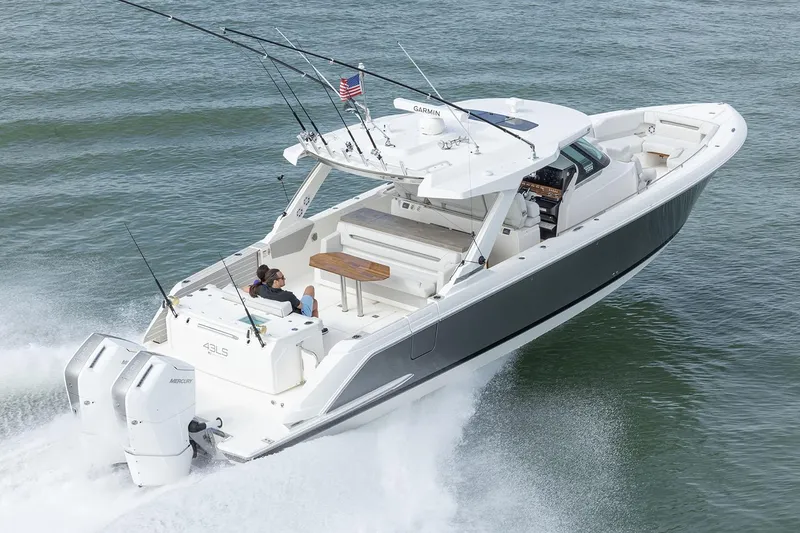 Slide: The Image of Manufacturer Provided Image: 2025 Tiara Yachts 43 LS cruising on water, featuring dual outboard engines. - 1