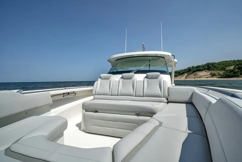Slide: The Image of Manufacturer Provided Image: 2025 Tiara Yachts 43 LS luxury boat with spacious seating, ocean view, and clear sky. - 11