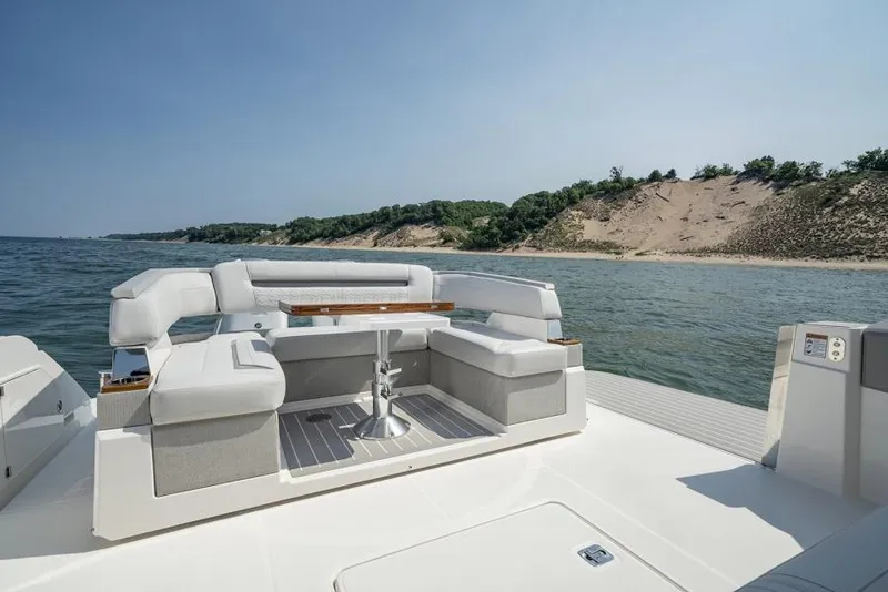 Slide: The Image of Manufacturer Provided Image: 2025 Tiara Yachts 43 LS luxury seating area with ocean view and sandy shoreline. - 17