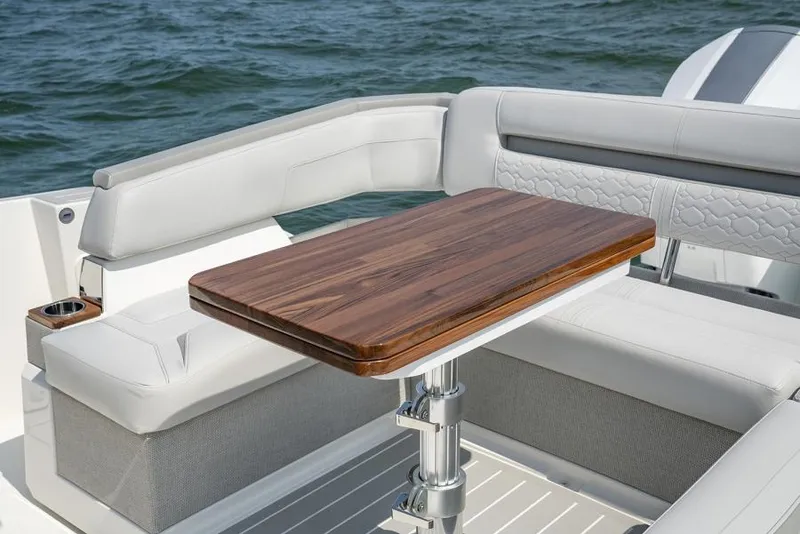 Slide: The Image of Manufacturer Provided Image: Luxurious seating area on 2025 Tiara Yachts 43 LS with elegant wooden table. - 18
