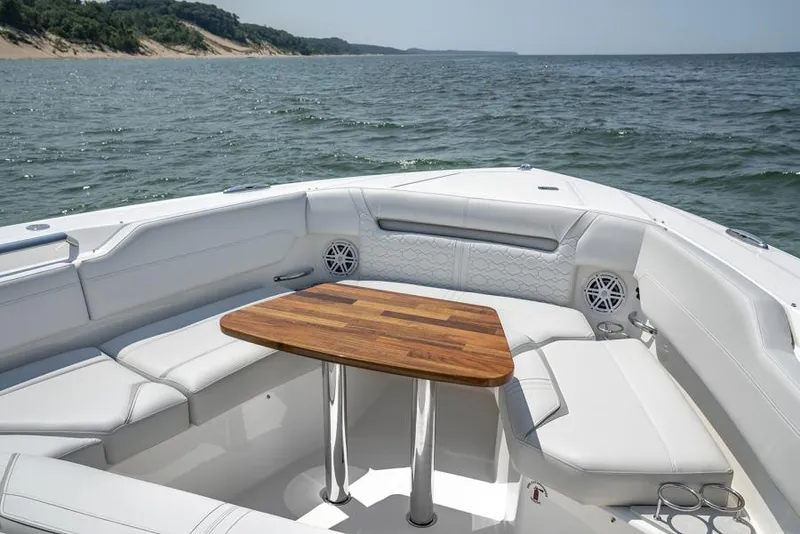 Slide: The Image of Manufacturer Provided Image: Luxurious seating area on 2025 Tiara Yachts 43 LS, featuring a wooden table and ocean view. - 9