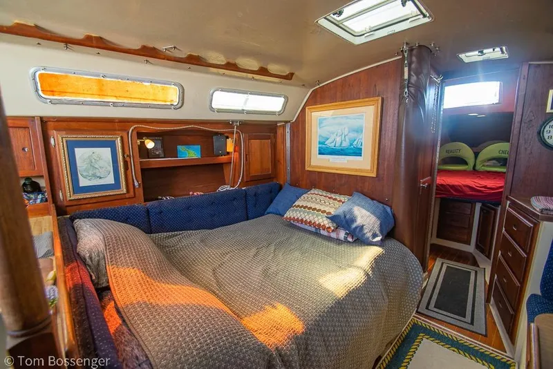 Slide: The Image of Cozy interior of a 1984 Catalina 36 sailboat with a comfortable bed and nautical decor. - 11