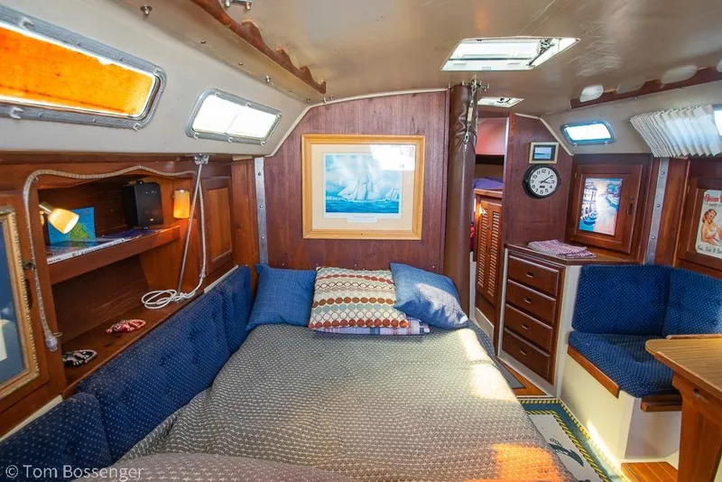 Slide: The Image of Cozy interior of 1984 Catalina 36 sailboat with bed, seating, and nautical decor. - 13