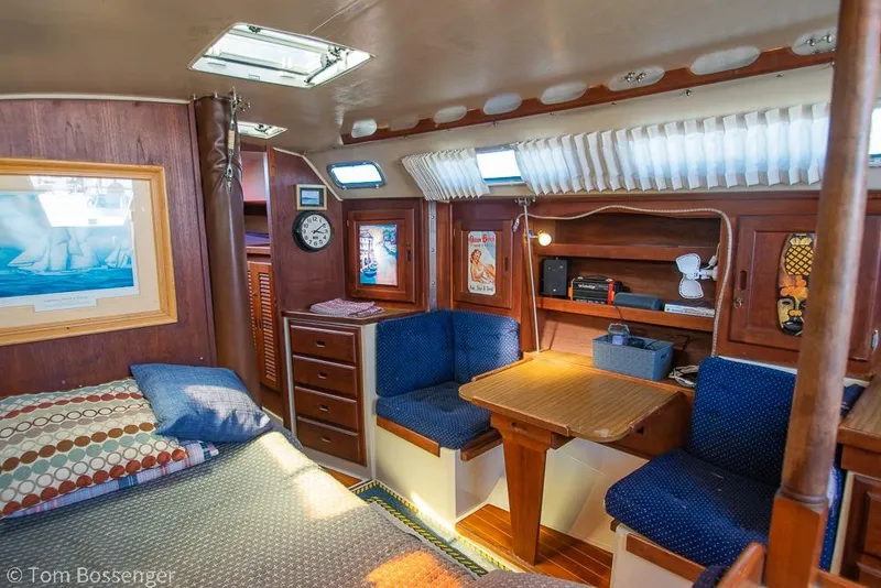 Slide: The Image of Interior of 1984 Catalina 36 sailboat with cozy seating and wooden furnishings. - 14
