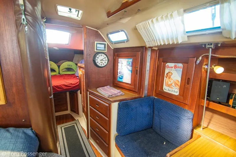Slide: The Image of Interior of 1984 Catalina 36 sailboat with cozy seating and vintage decor. - 17