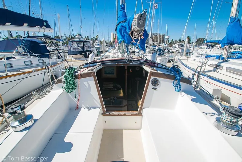 Slide: The Image of 1984 Catalina 36 sailboat cockpit view in marina, surrounded by other boats. - 24