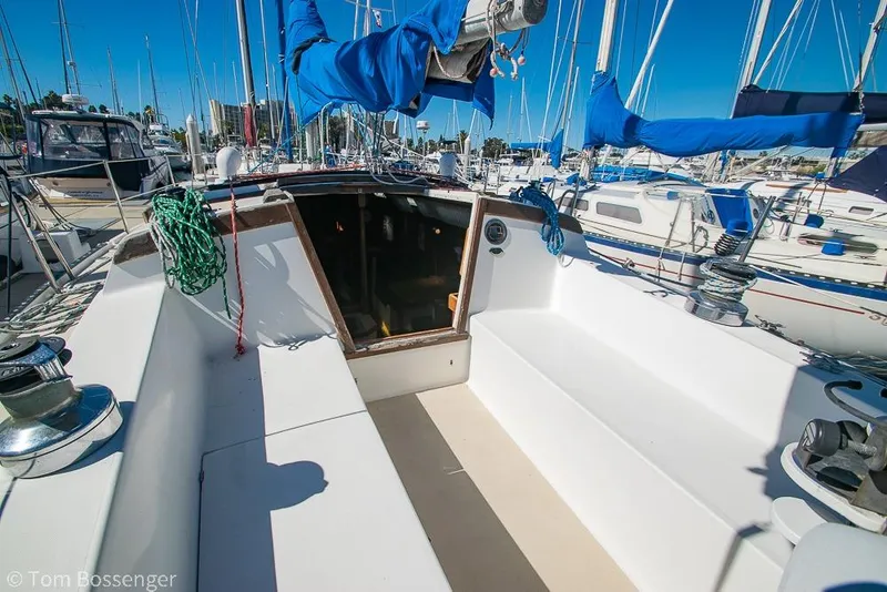 Slide: The Image of 1984 Catalina 36 sailboat cockpit with blue sail covers, docked in a marina. - 25
