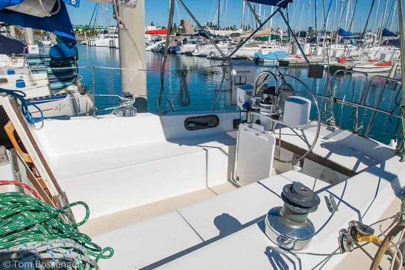 Slide: The Image of 1984 Catalina 36 sailboat cockpit with marina view, featuring winches and steering wheel. - 3