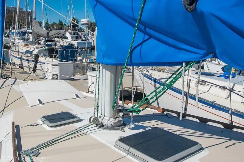 Slide: The Image of 1984 Catalina 36 sailboat docked, featuring blue sail cover and rigging. - 30