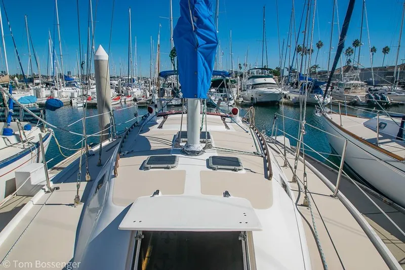 Slide: The Image of 1984 Catalina 36 sailboat docked in a marina, surrounded by other boats. - 32