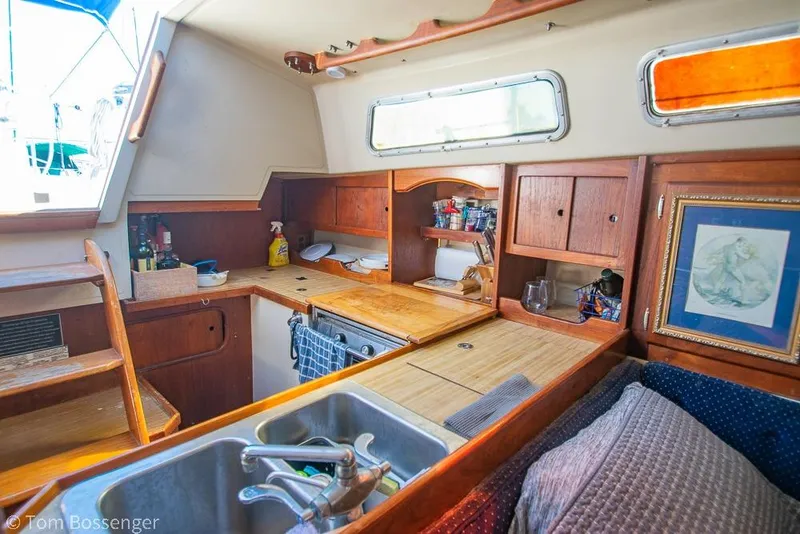 Slide: The Image of Interior of 1984 Catalina 36 sailboat kitchen with wooden cabinetry and sink. - 7