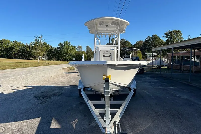 Slide: The Image of 2026 Sea Pro 202 Center Console boat on trailer, parked outdoors under clear blue sky. - 10