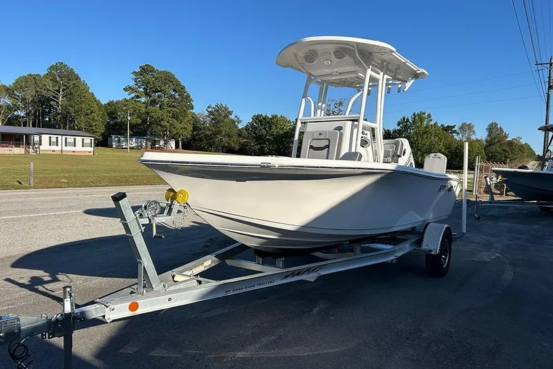 Slide: The Image of 2026 Sea Pro 202 Center Console boat on trailer, parked outdoors. - 11