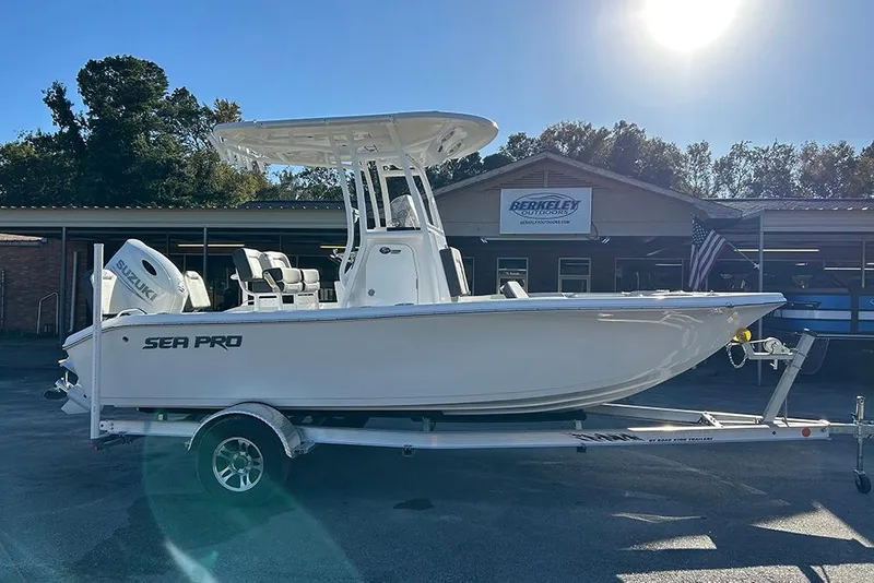 Slide: The Image of 2026 Sea Pro 202 Center Console boat on trailer, parked outdoors under clear sky. - 13