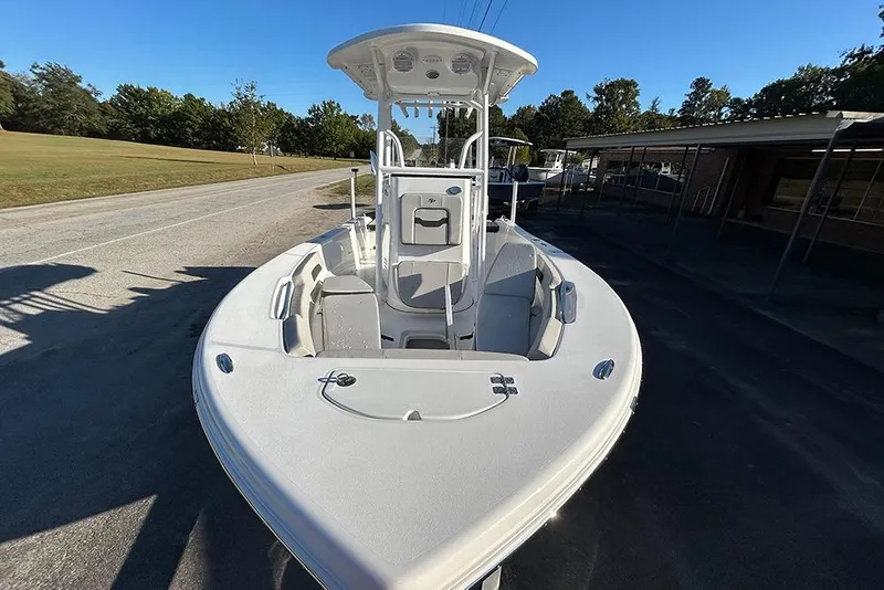 Slide: The Image of 2026 Sea Pro 202 Center Console boat on a sunny day, parked on a paved area. - 14